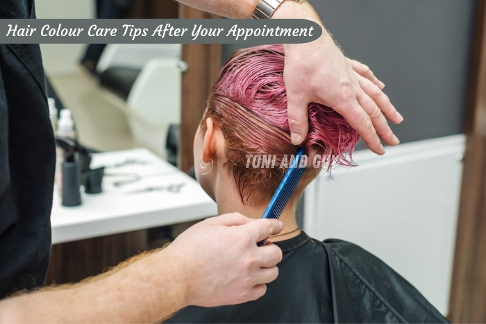 Toni & Guy, Coimbatore Expert stylist combing freshly coloured pink hair for perfect finish