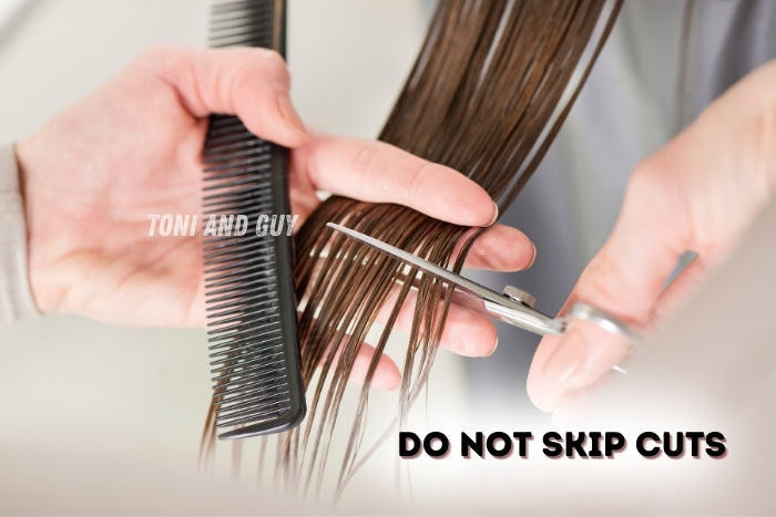 A stylist performing a professional haircut at TONI & GUY Coimbatore to maintain healthy hair