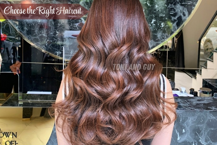 A client flaunting beautiful wavy brown hair styled at TONI & GUY Coimbatore for a perfect finish