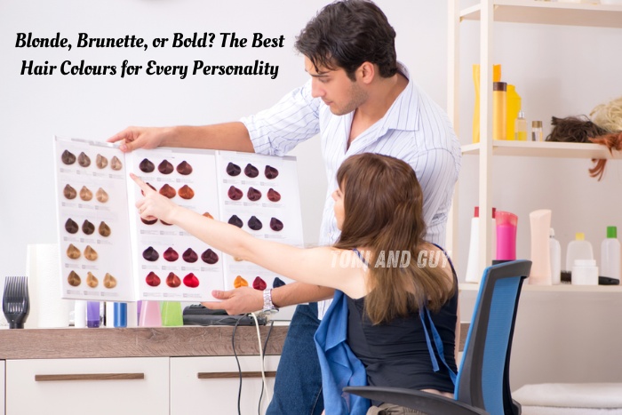 A stylist at TONI & GUY Coimbatore helping a client choose from a range of vibrant hair colour shades