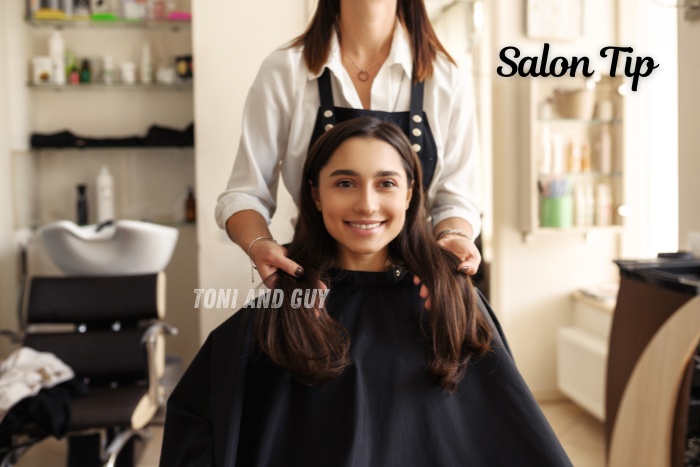 Stylist giving a salon tip while preparing the client’s hair for styling by Toni & Guy in Coimbatore