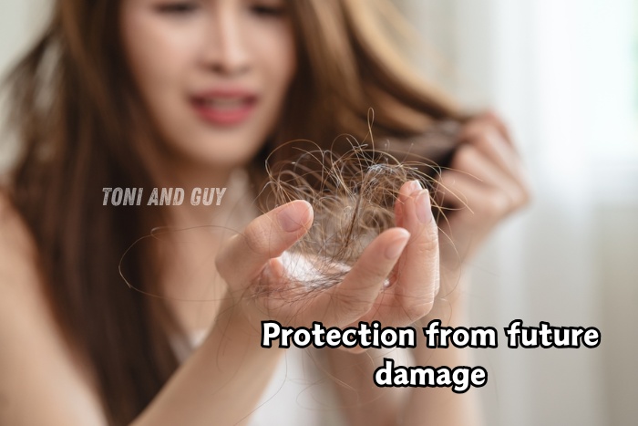 Woman experiencing hair fall and breakage holding damaged hair strands at Toni & Guy Coimbatore